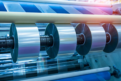 laminating mylar into rollstock indsutrial machines that pul and press material structures together into a film roll